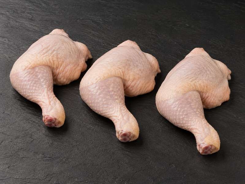 Three raw chicken double legs, thigh and drumstick joined